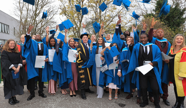 A group of graduates celebrate at their conferring ceremony